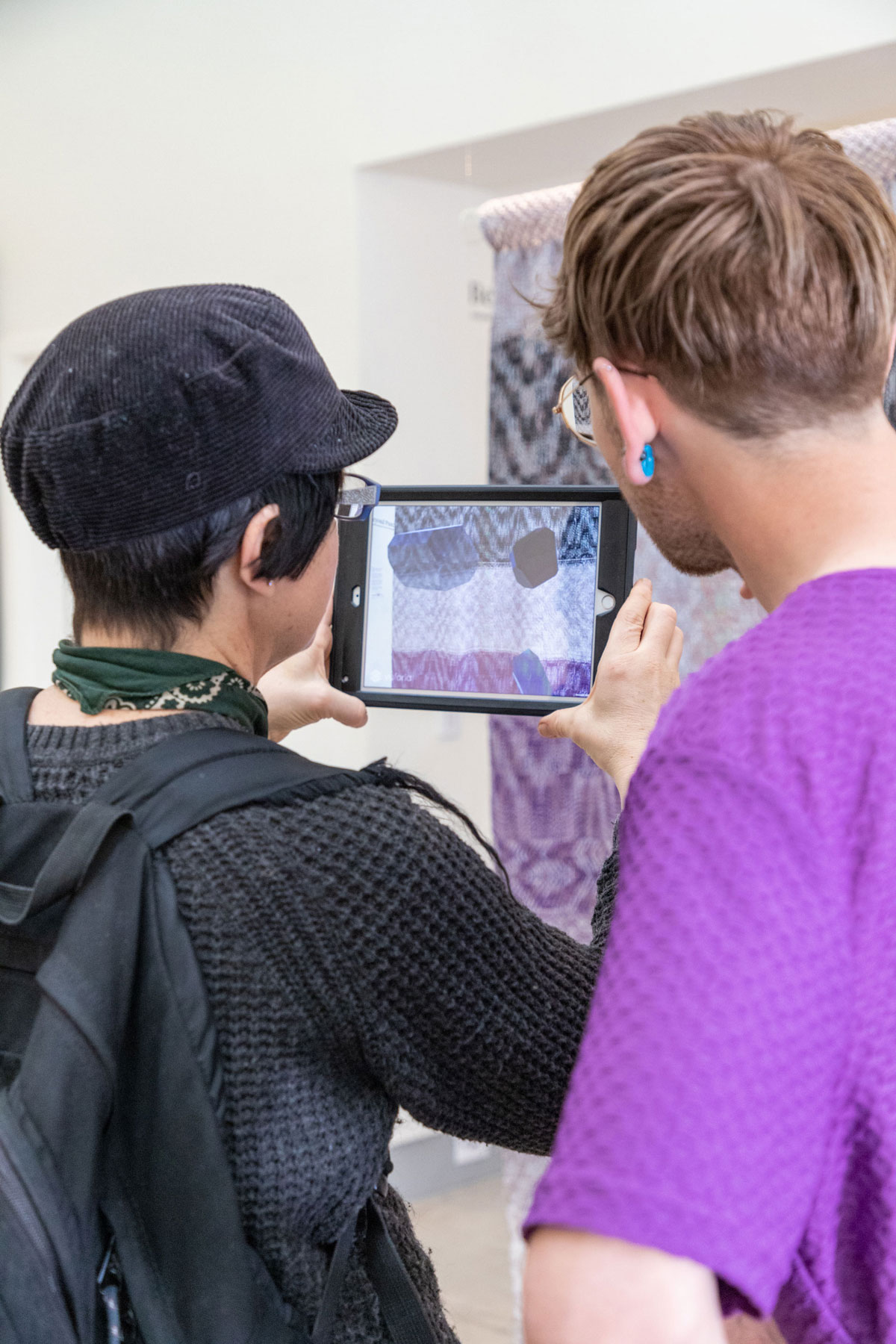 Photo showing a scaled floor plan on a wooden surface, on top of a black plinth. They served as the visual tag to activate the augmented reality experience.